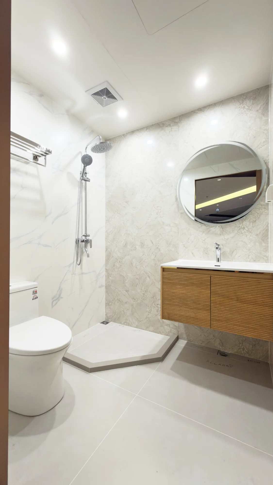 Apartment bathroom sample with vanity, toilet and shower
