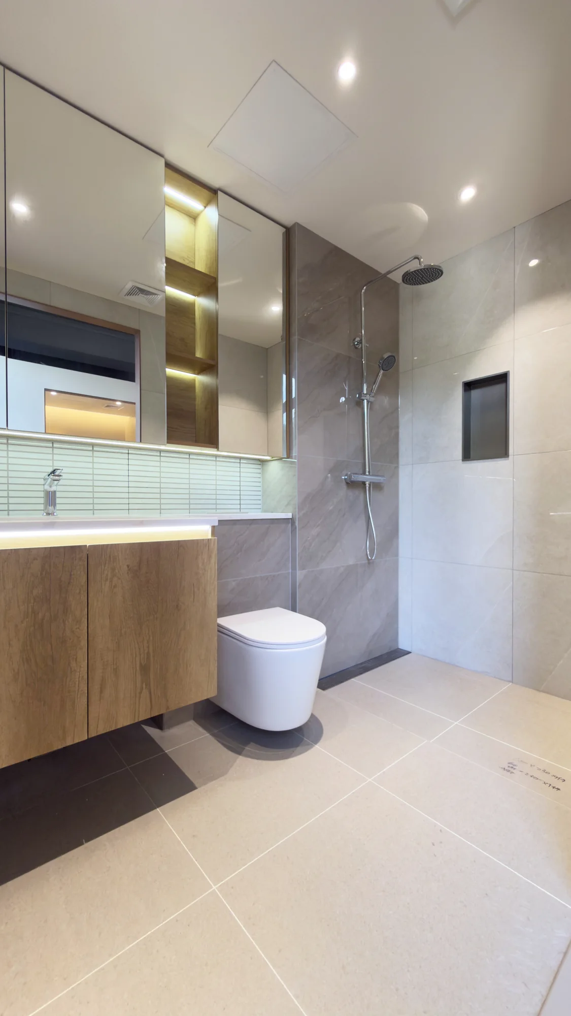 Hotel bathroom sample with vanity, toilet and glass shower